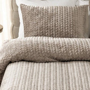 closer view: Close-up of Whisper taupe duvet cover and matching pillow showing raised chevron detailing in vertical rows